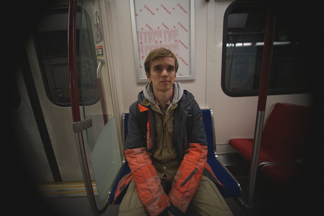 Producer sitting on subway seat