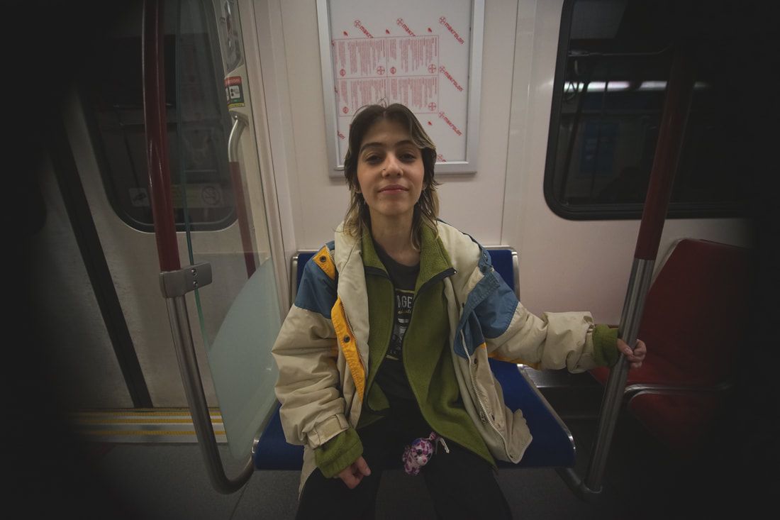 Director sitting on subway seat