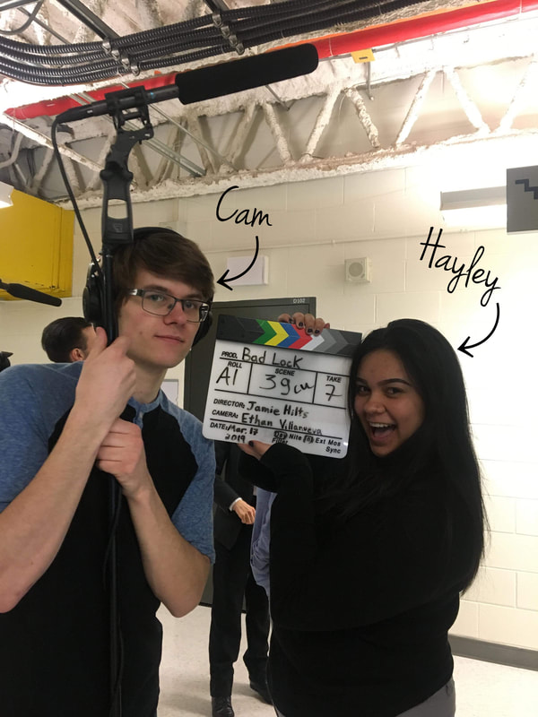 Cam posing with boom mic, Hayley posing with movie slate